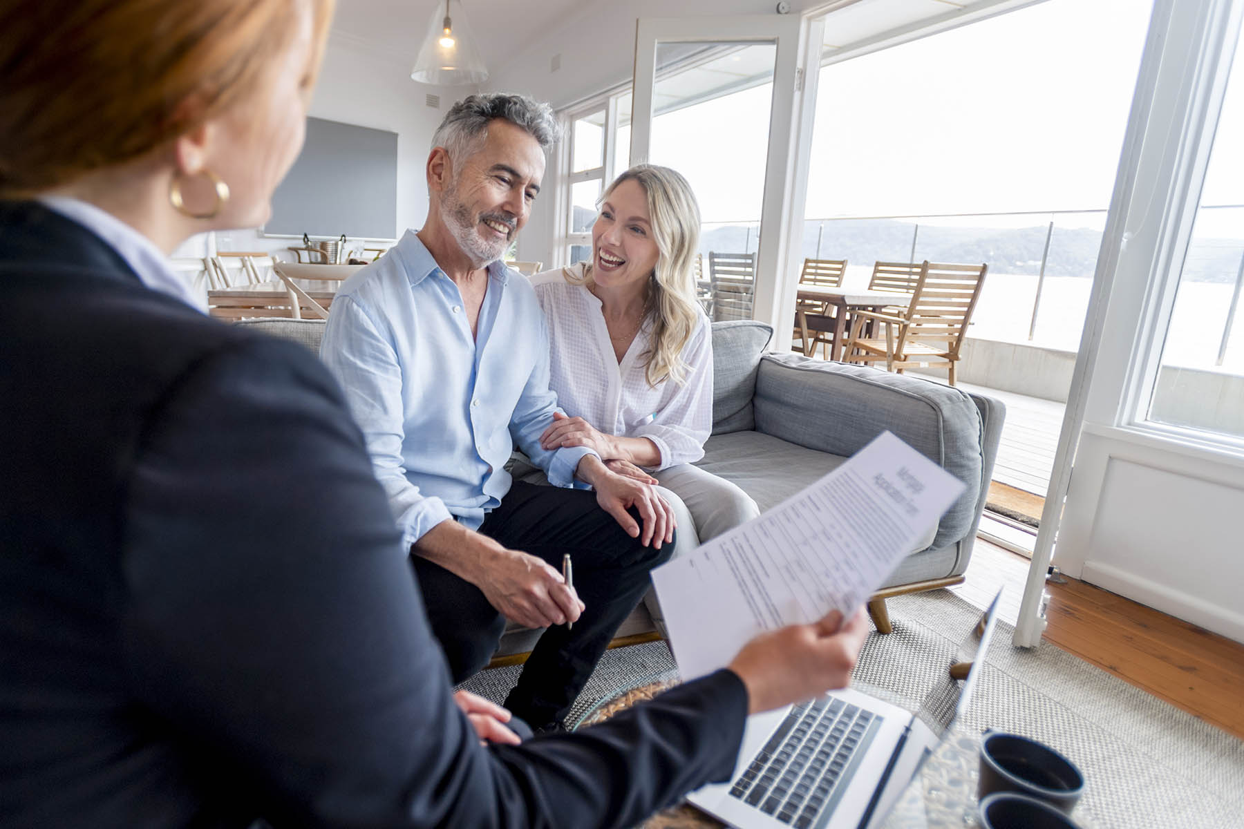 Happy mature couple meeting investments and financial advisor at home